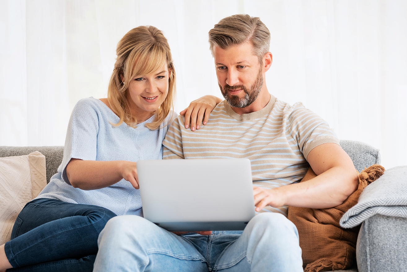 A couple researches the benefits of a home equity line of credit on their laptop.