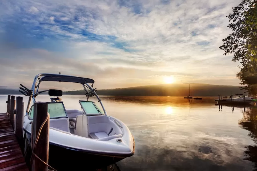 A boat docked in calm water with a scenic background.